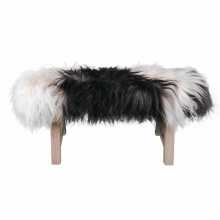Bench covered with a black & white Icelandic sheepskin
